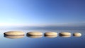 Zen stones row from large to small in water Royalty Free Stock Photo