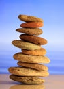 Zen stones stack on blue sky and sea background Royalty Free Stock Photo