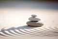 Zen stones stack on raked sand in a minimalist setting for balance and harmony Royalty Free Stock Photo