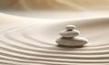 Zen stones stack on raked sand in a minimalist setting for balance and harmony Royalty Free Stock Photo