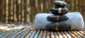 Zen stones stacked on a bamboo mat, spa concept emphasizing balance and calm. Ideal for wellness and relaxation themes Royalty Free Stock Photo