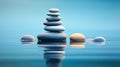 Zen stones symmetrically aligned against calm water