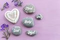 zen stones with the words Mind body soul. purple wooden background