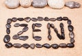Zen word written with pebbles on the sand Royalty Free Stock Photo