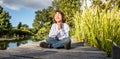 Zen young yoga child meditating alone to breathe near water