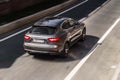 zenith view of Maserati levante premium SUV car driving on highway road. Rear aerial view