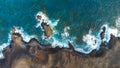 zenithal aerial drone view of waves crashing against cliffs Royalty Free Stock Photo