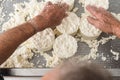 zenithal shot of a man& x27;s hands preparing the curd moulds for making fresh cheese.