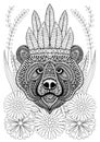 Zentangle stylized bear with war bonnet on flowers. Hand drawn e