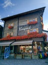 Zermatt, Switzerland - August 22, 2019: Beautiful traditional wooden Swiss chalet with vibrant flowers on the window sills.