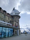 Zermatt, Switzerland - August 22, 2019: View of the Kulmhotel Gornergrat observatory. Tourists relax on the hotel terrace and