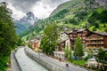 Zermatt cityscape with Matter Vispa river view and wooden houses and people and Matterhorn summit in background during summer in