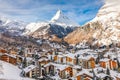 Snowcapped village with background of iconic mountain peak Matterhorn