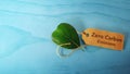 Zero Carbon Emission and ESG Concepts. Clean Energy. Close-up of Green leaf a Recycling Paper Tag. Produce a Green Power.