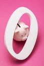 Zero and piggy bank on a colored background. Concept on the topic of zeroing deposits Royalty Free Stock Photo