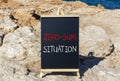 Zero-sum situation symbol. Concept words Zero-sum situation on beautiful black blackboard. Chalkboard. Beautiful stone sea sky Royalty Free Stock Photo