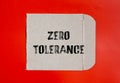 Zero tolerance words written on torn paper with red background Royalty Free Stock Photo
