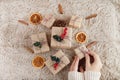 Zero waste Christmas flat lay. Hands holding simple christmas gift. Plastic free sustainable lifestyle