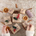 Zero waste Christmas flat lay. Hands holding simple christmas gift. Plastic free sustainable lifestyle