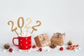 Zero waste Christmas or New Year 2022 concept. Hot chocolate in red mug, Eco friendly packaging gifts and golden numbers