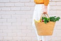 Zero waste concept with copy space. Woman holding straw basket with vegetables, products. Eco friendly shopper. Zero waste,