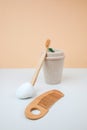 Zero waste concept, eco friendly. A mug for drinks, wooden toothbrush and comb