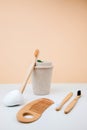 Zero waste concept, eco friendly. A mug for drinks, wooden toothbrush and comb