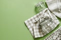 Zero waste concept - reusable cotton bags and glass jars on green background