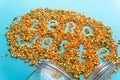 Zero waste creative handwritten text. Colorful legumes: red lentils and split peas scattered scattered from glass jar at