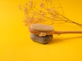 Zero waste dry massage wooden brush on yellow