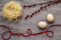 Zero waste Easter concept. Wooden egg, bird`s nest, satin ribbon, red willow seals. No plastic, eco trend. Gray concrete Royalty Free Stock Photo