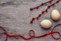 Zero waste Easter concept. Wooden egg, satin ribbon, red willow seals. No plastic, eco trend. Gray concrete background Royalty Free Stock Photo