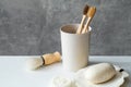 Zero waste eco friendly bathroom accessories on table. Natural bamboo toothbrushes in holder, homemade soap, loofah, shaving brush Royalty Free Stock Photo