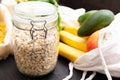 Zero waste grocery shopping. Package-free food on dark wooden table with texture. Fresh vegetables and fruits in Eco cotton bags. Royalty Free Stock Photo