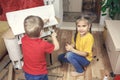 Zero waste home activity. Kids doing paper house with cardboard box, creatively thinking concept