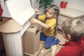 Zero waste home activity. Kids doing paper house with cardboard box, creatively thinking concept