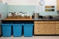 zero-waste kitchen, with compost bin and recycling containers visible