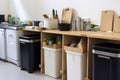 zero-waste kitchen, with compost bin and recycling containers visible