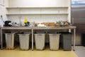 zero-waste kitchen, with compost bin and recycling containers visible