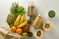 Zero waste and plastic free concept. Grocery shopping eco bag with fruits and cereals in glass jars, white background. Flat lay, Royalty Free Stock Photo