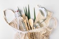 Zero waste, plastic-free and eco-friendly lifestyle. Cotton mesh bag, glass bottle, jar and bamboo cutlery for package free