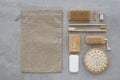Zero waste set of wooden bath accessories: laundry soap, body sponge on a concrete background. Top view