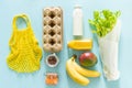 Zero waste shopping concept - groceries and reusable bags on blue background Royalty Free Stock Photo