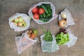 Zero waste shopping concept. No single-use plastic. Fresh organic vegetables, fruits and greens in reusable recycled mesh produce