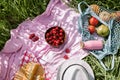 Zero waste summer picnic on the with cherries in the wooden coconut bowl, fresh bread and glass bottle of juice or smoothie