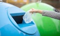 Zero Waste. Woman throwing single use plastic bag into blue recycle bin Royalty Free Stock Photo