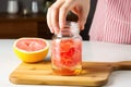 zesting a grapefruit into a glass jar Royalty Free Stock Photo