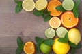 Zesty display Oranges, lemons, limes, grapefruit, and mint on wood