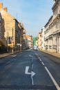 Long straight street between old tenement houses at sunny day