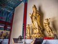 Golden Goddess of Compassion or Guanyin goddess Statue in Tianmen Temple Hall on tianmen mountain zhangjiajie city China.